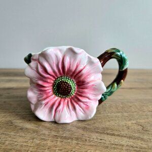 Vintage ceramic mug with large pink flower design.
